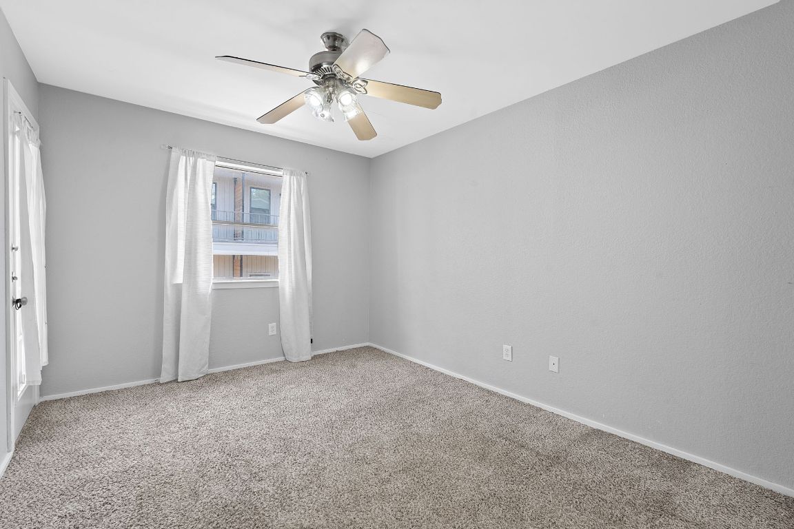 2104 Cullen Avenue, Unit 4224 Austin, TX 78757 - Photo 14 of 24 an empty room with windows and fan