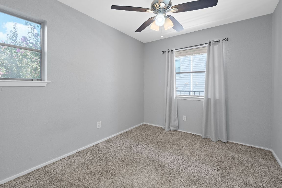 2104 Cullen Avenue, Unit 4224 Austin, TX 78757 - Photo 19 of 24 an empty room with windows and fan