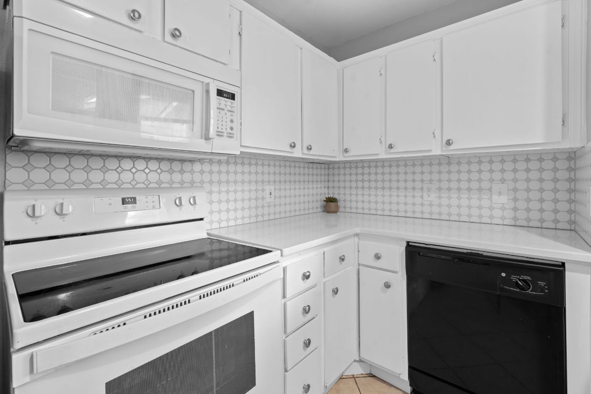 2104 Cullen Avenue, Unit 4224 Austin, TX 78757 - Photo 3 of 24 a kitchen with white cabinets appliances and sink
