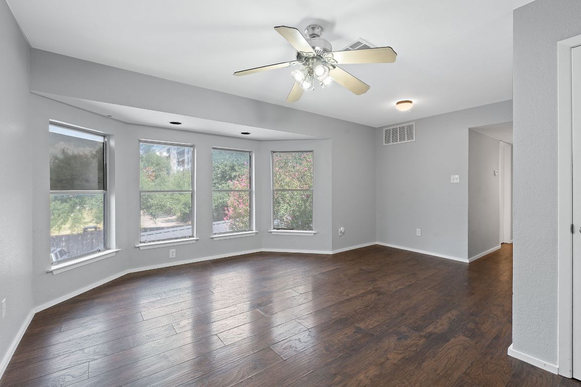 2104 Cullen Avenue, Unit 4224 Austin, TX 78757 - Photo 8 of 24 a view of an empty room with wooden floor and a window