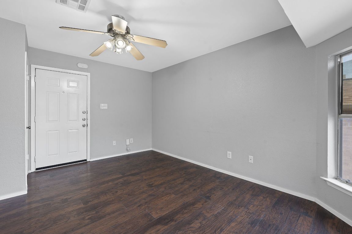 2104 Cullen Avenue, Unit 4224 Austin, TX 78757 - Photo 9 of 24 a view of an empty room with wooden floor and a window