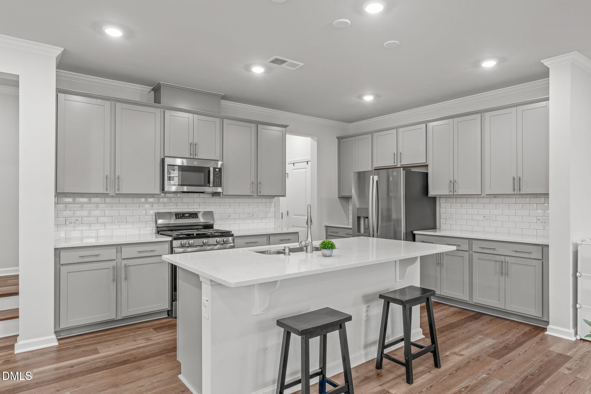 1809 Barrett Run Trail Apex, NC 27502 - Photo 4 of 23 a kitchen with refrigerator cabinets and wooden floor