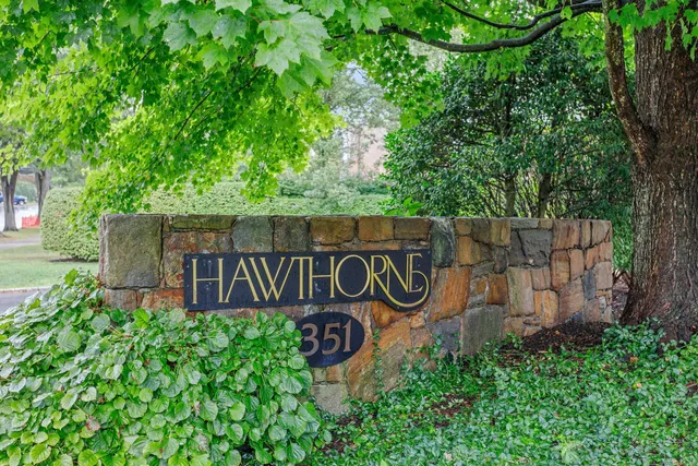 a sign that is sitting on a wooden fence