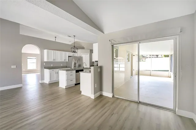 a view of a kitchen with wooden floor