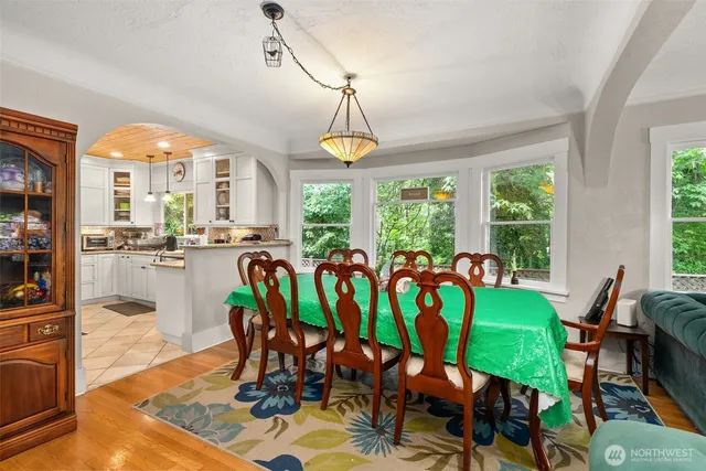 a kitchen with stainless steel appliances granite countertop a stove a refrigerator and wooden cabinets