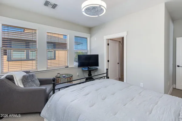a bedroom with bed couch and window