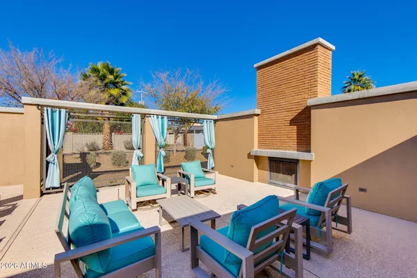 a view of a patio with table and chairs and potted plants