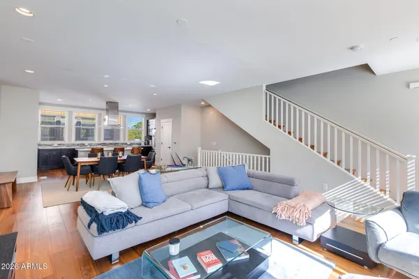 a living room with furniture and wooden floor