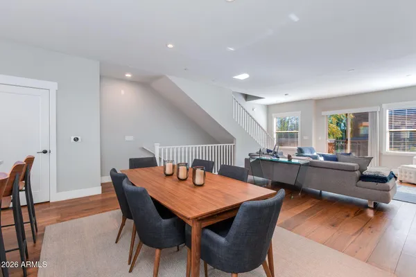 a dining room with furniture and wooden floor