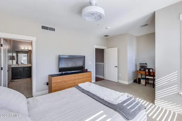 a bedroom with furniture and a flat screen tv
