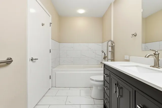 a bathroom with a sink a toilet and bathtub