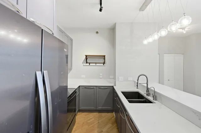 a kitchen with stainless steel appliances a sink a refrigerator and a stove