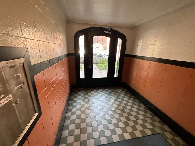 a view of a hallway with wooden floor and stairs