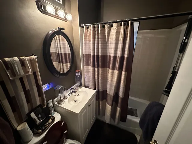 a bedroom with bed and wooden floor