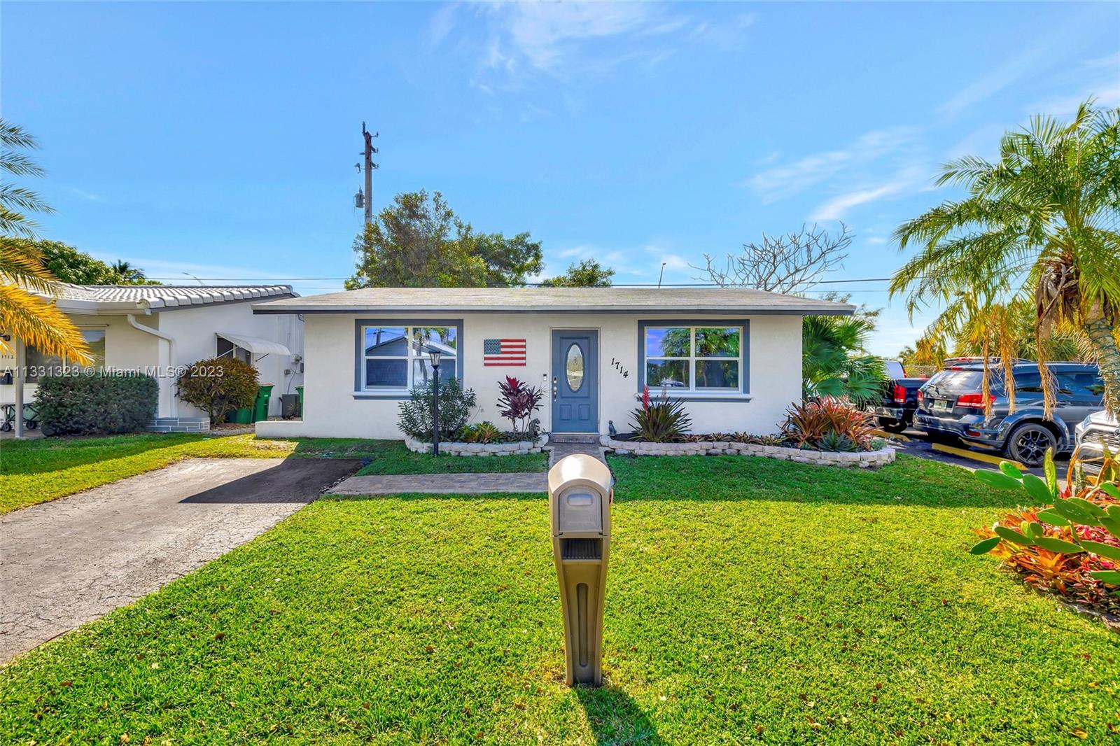 1714 Northwest 45th Court Tamarac, FL 33309 - Photo 1 of 29 a front view of a house with garden and porch