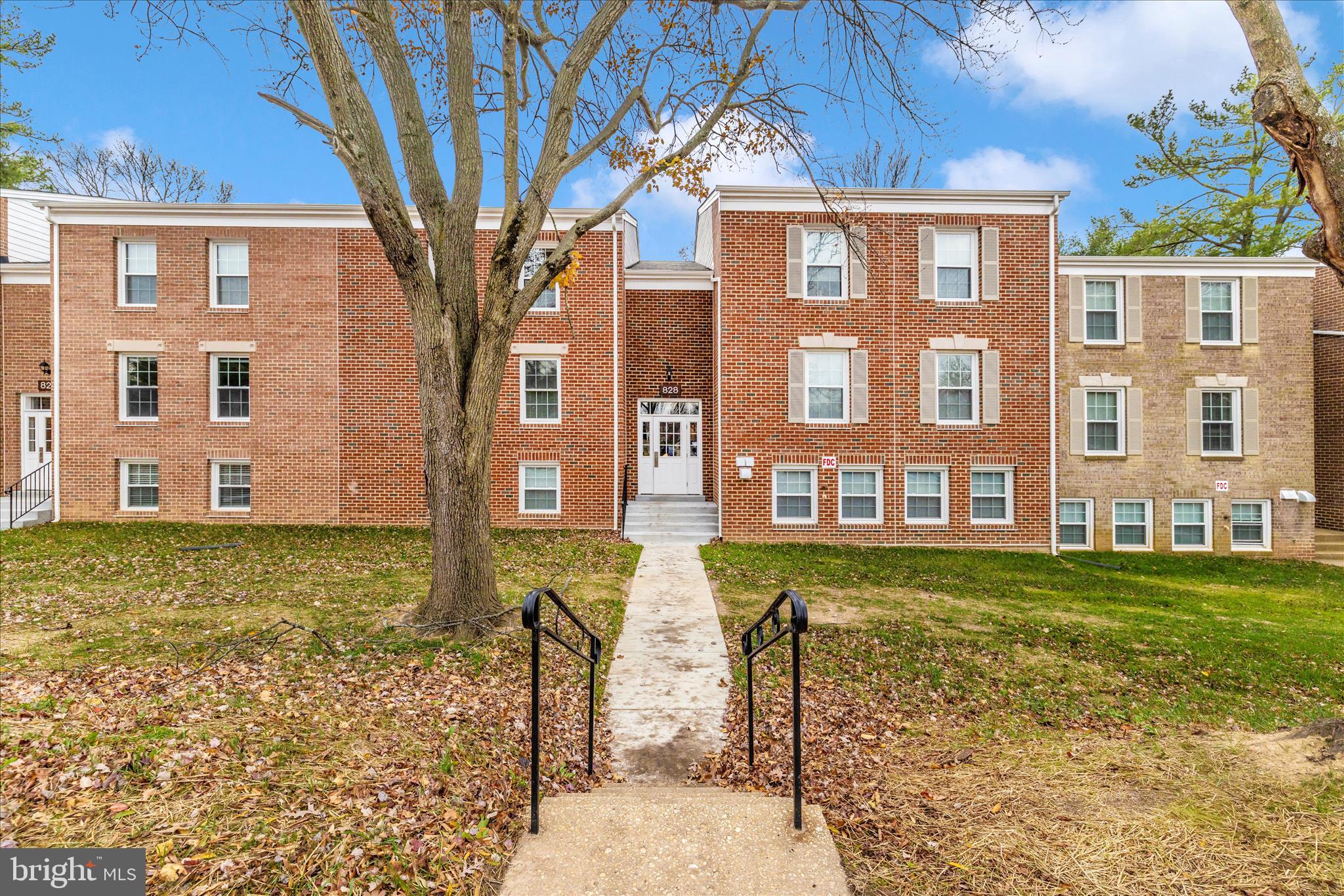a view of a brick building next to a yard