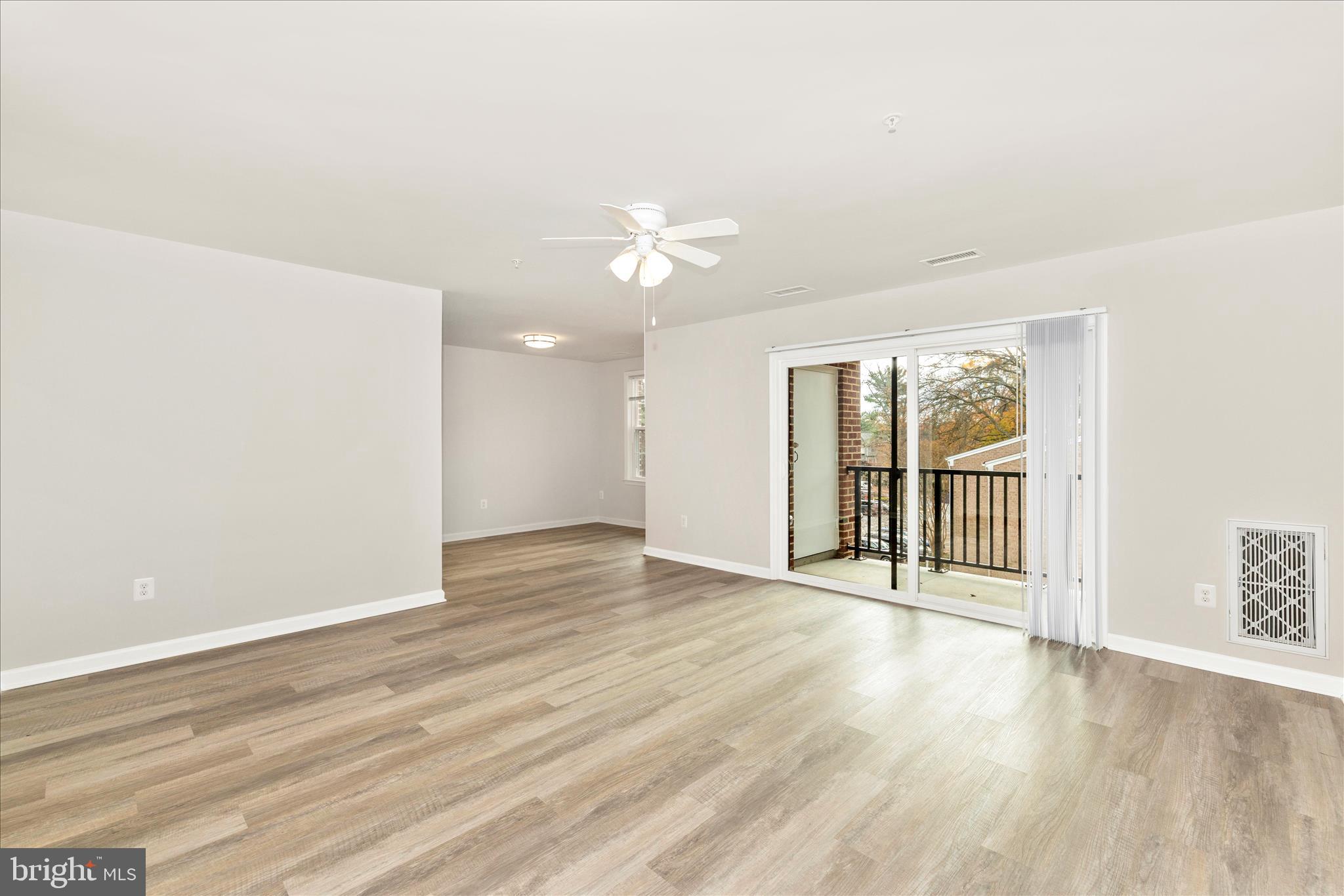 828 Quince Orchard Boulevard, Unit 82820 Gaithersburg, MD 20878 - Photo 16 of 51 wooden floor in an empty room with a window