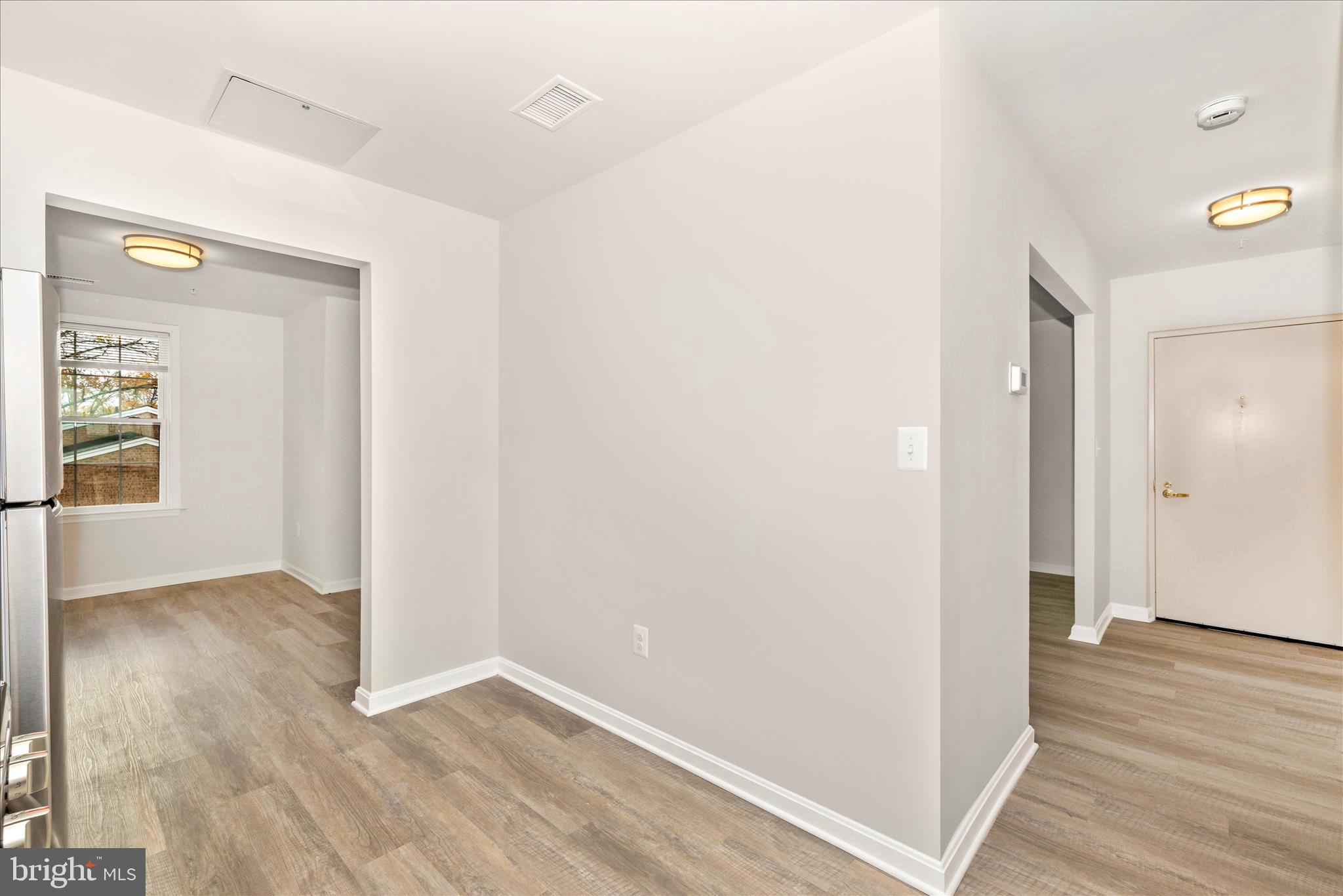 828 Quince Orchard Boulevard, Unit 82820 Gaithersburg, MD 20878 - Photo 32 of 51 wooden floor in an empty room with a window