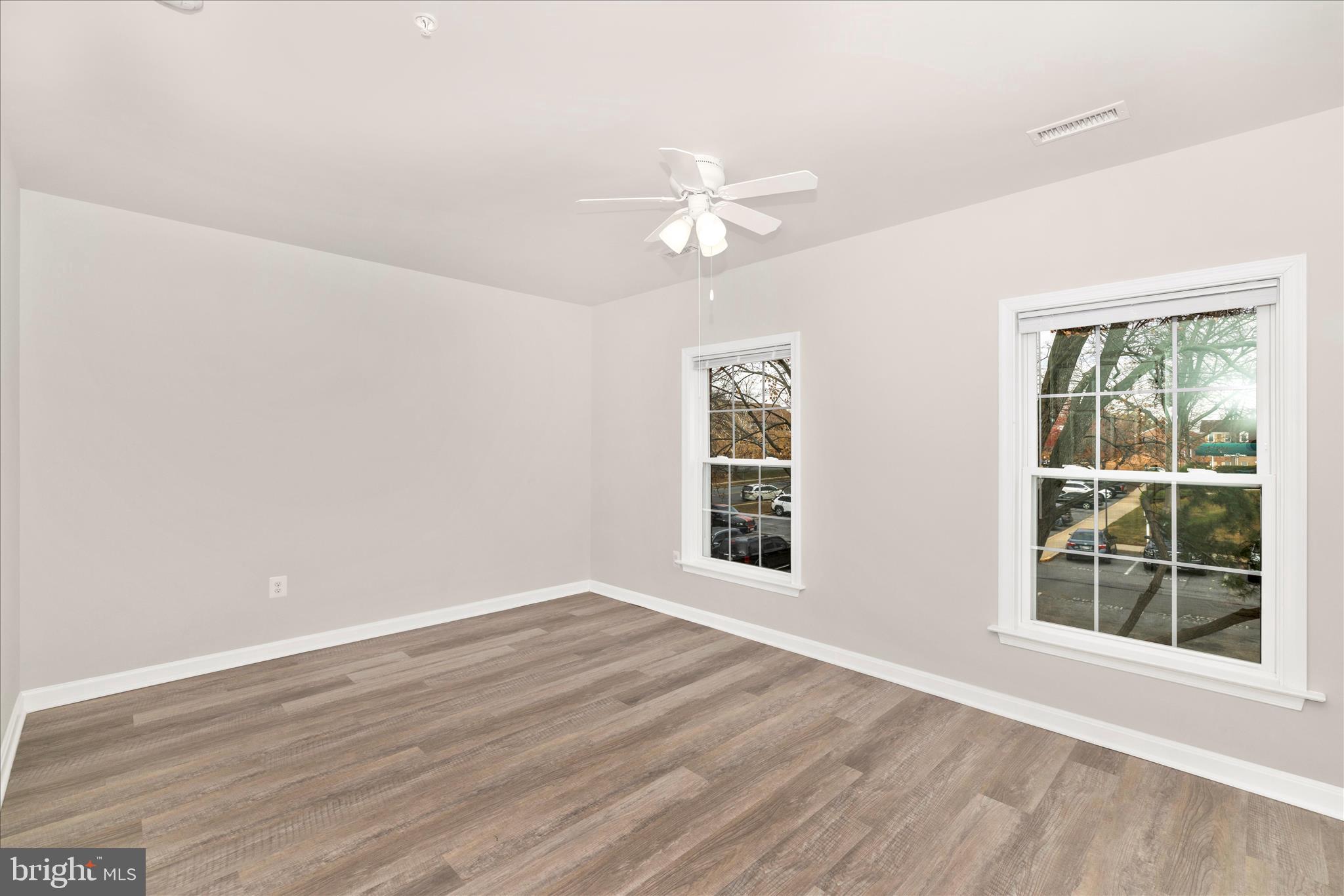 828 Quince Orchard Boulevard, Unit 82820 Gaithersburg, MD 20878 - Photo 33 of 51 wooden floor in an empty room with a window