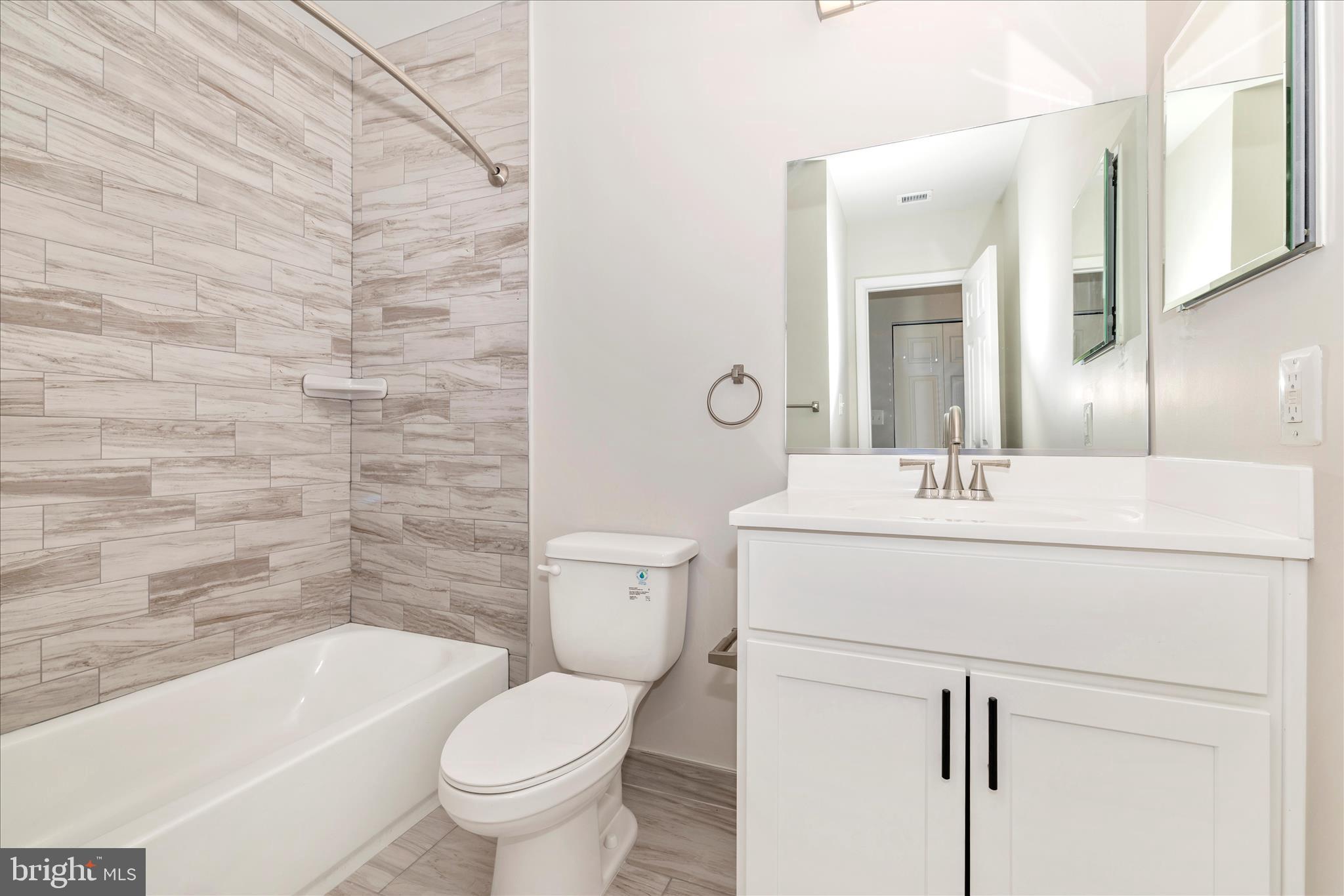 828 Quince Orchard Boulevard, Unit 82820 Gaithersburg, MD 20878 - Photo 41 of 51 a bathroom with a sink toilet and shower