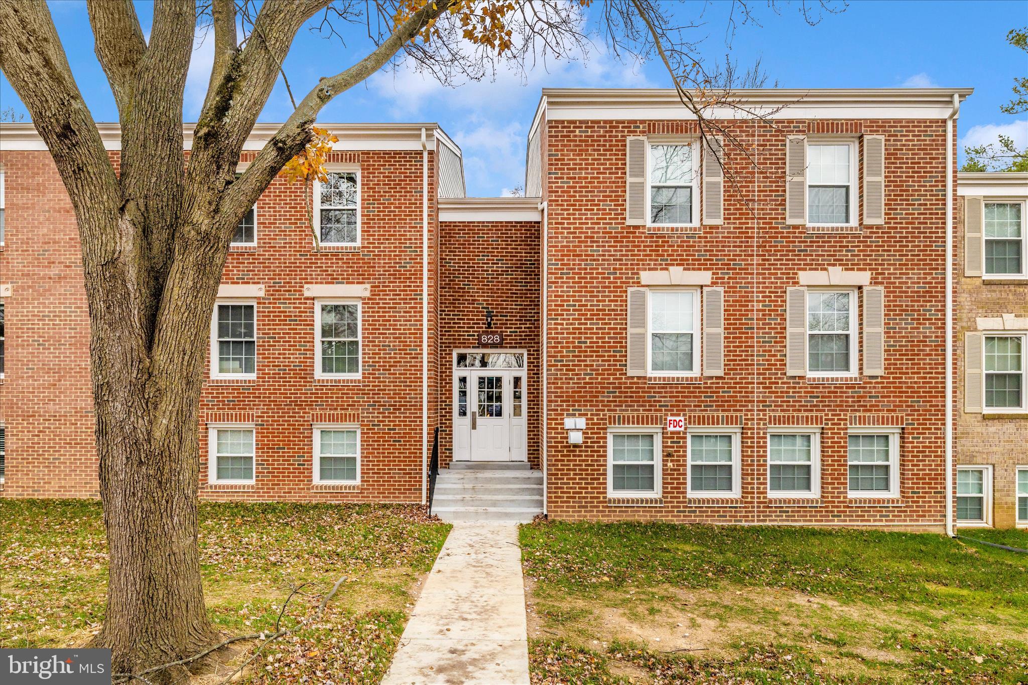 828 Quince Orchard Boulevard, Unit 82820 Gaithersburg, MD 20878 - Photo 43 of 51 a front view of a house with a yard
