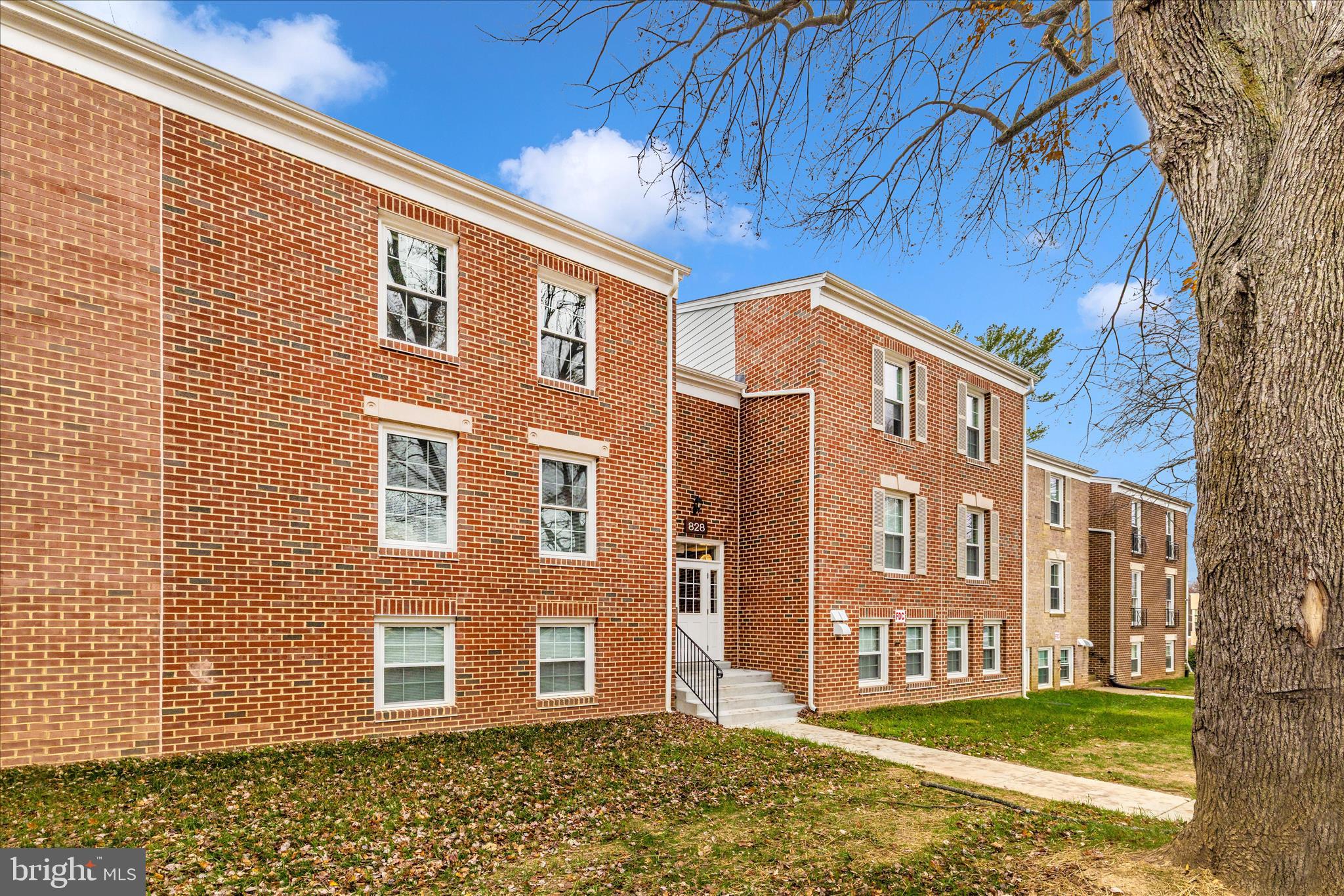 828 Quince Orchard Boulevard, Unit 82820 Gaithersburg, MD 20878 - Photo 45 of 51 a front view of a house with a yard