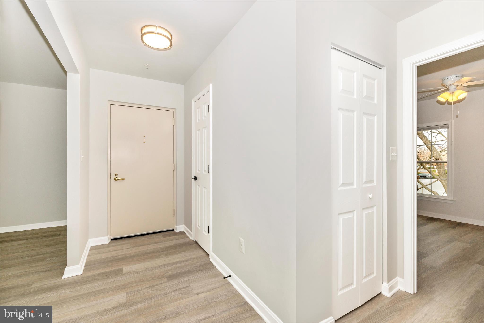 828 Quince Orchard Boulevard, Unit 82820 Gaithersburg, MD 20878 - Photo 5 of 51 a view of a hallway with wooden floor and closet area