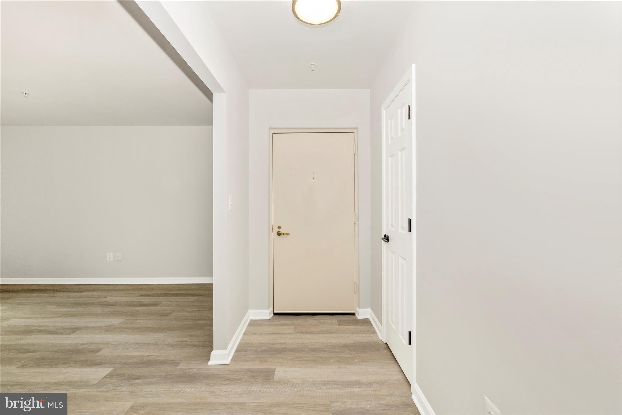 828 Quince Orchard Boulevard, Unit 82820 Gaithersburg, MD 20878 - Photo 6 of 51 a view of a hallway with wooden floor