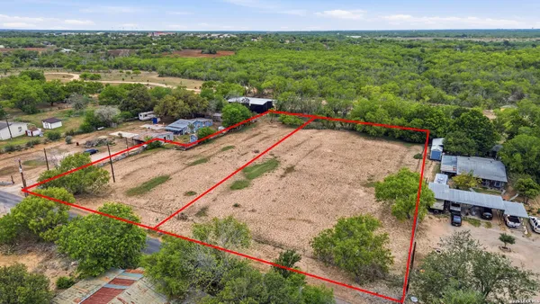 an aerial view of a house with a yard