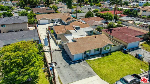 an aerial view of residential houses with outdoor space