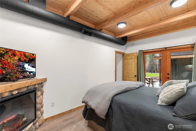 a bedroom with a bed and a television