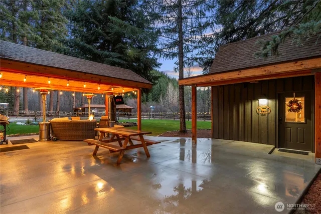 a view of a patio with a table chairs and a backyard