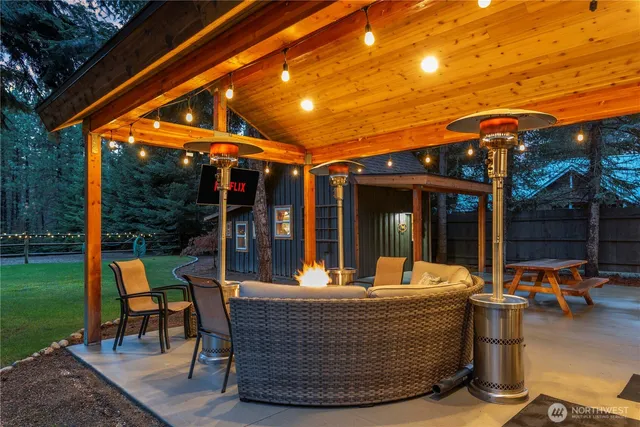 a view of a patio with table and chairs and potted plants