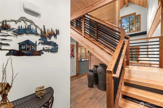 a view of entryway and hall with wooden floor