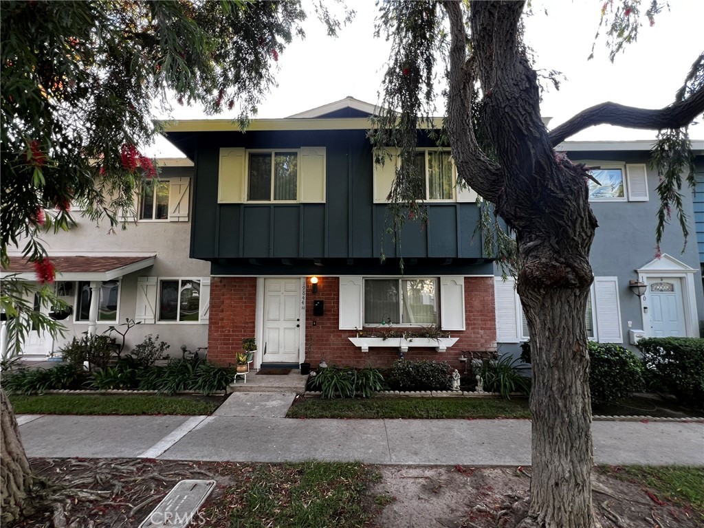 19844 Inverness Lane Huntington Beach, CA 92646 - Photo 2 of 2 a front view of a house with yard and green space