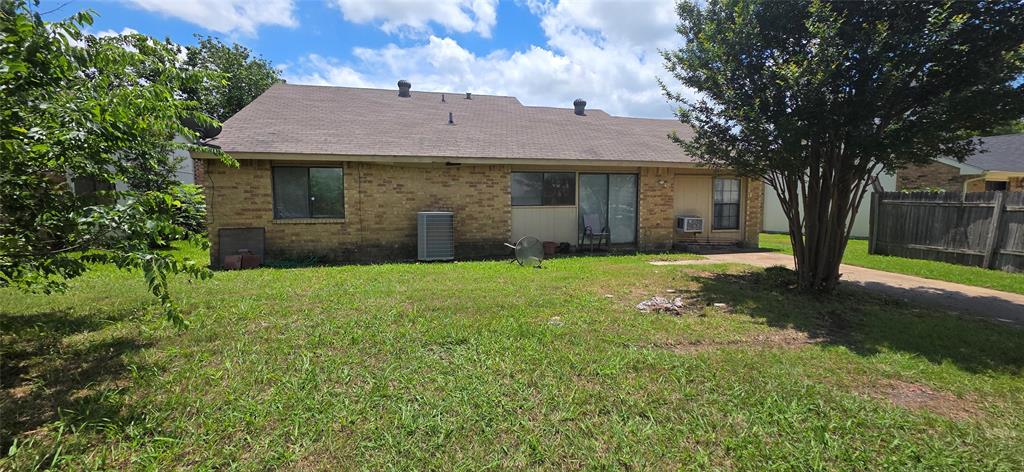 1323 Timberview Drive Allen, TX 75002 - Photo 14 of 14 Rear exterior featuring brick siding, a brown shingle roof, and a sliding glass door