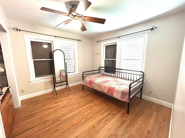 a bedroom with a bed window and a chandelier