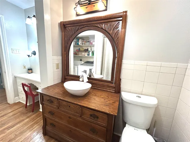 a bathroom with a toilet a sink and a mirror