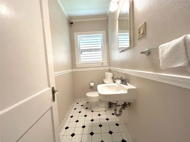a bathroom with a sink a toilet a shower and a mirror