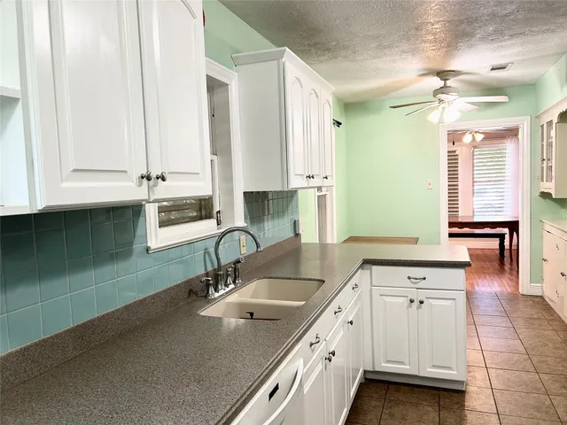 a kitchen with sink cabinets and window