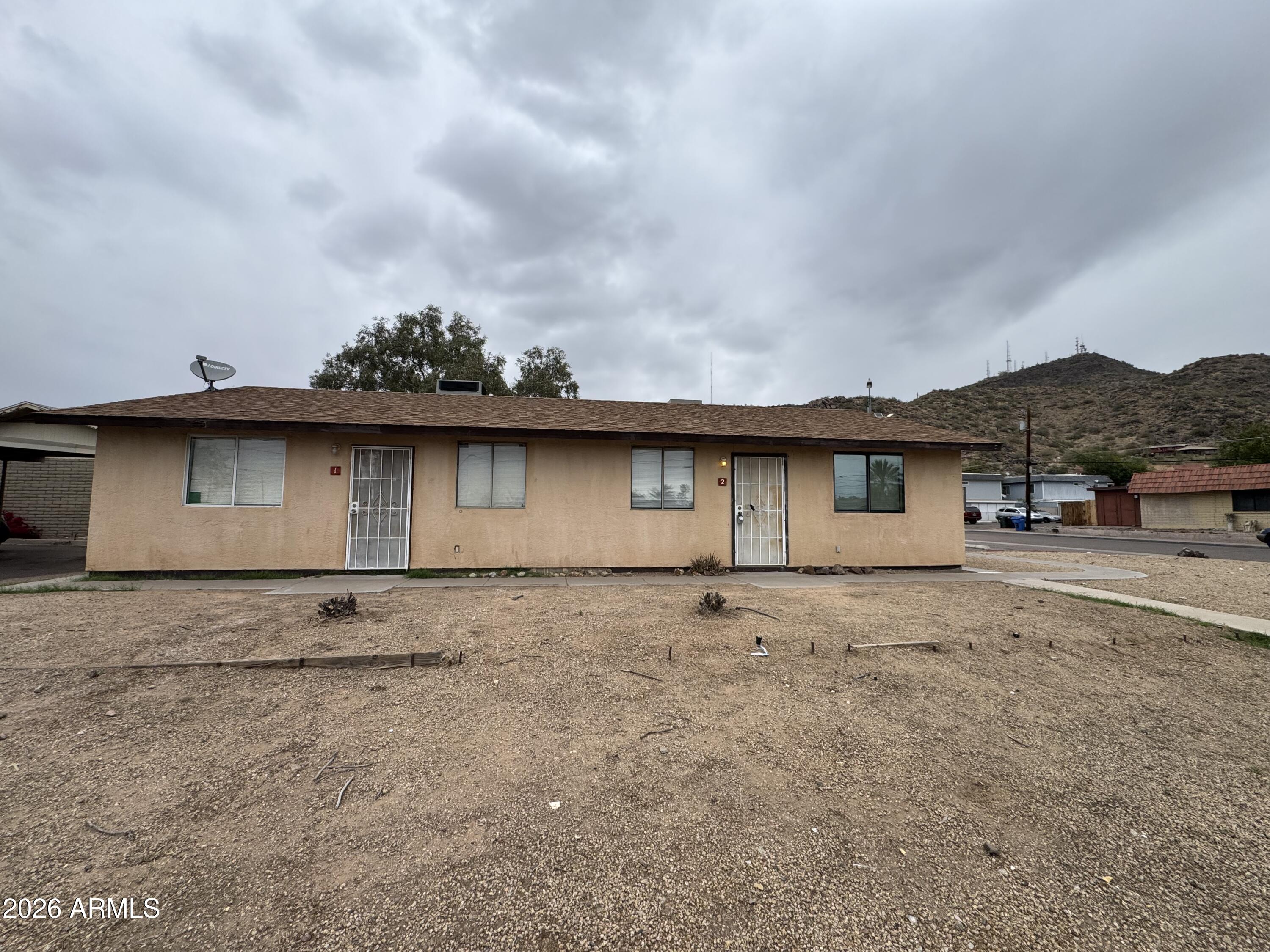 1702 West Shangri-la Road Phoenix, AZ 85029 - Photo 1 of 25 front view of a house with a street