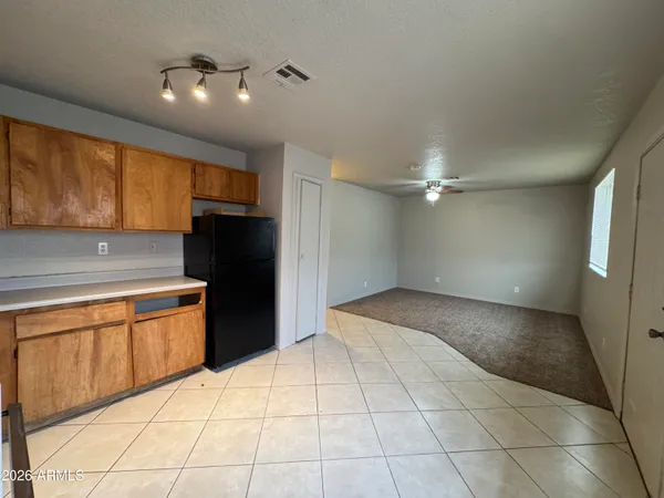 a kitchen with granite countertop a refrigerator and a stove top oven