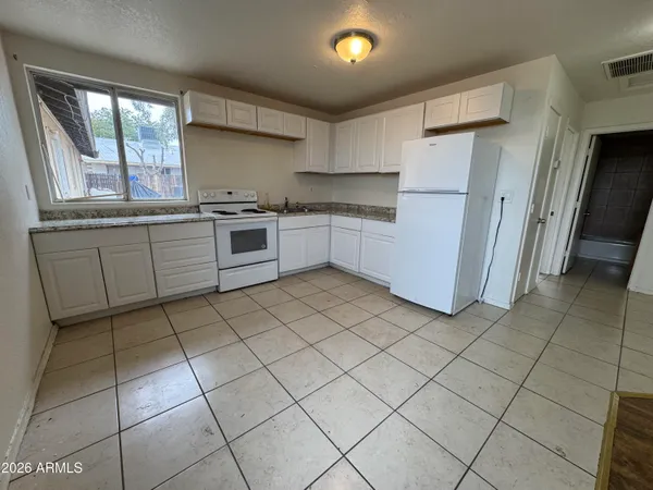 a kitchen with a stove a sink and a refrigerator