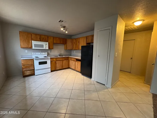 a kitchen with stainless steel appliances granite countertop a refrigerator and a stove top oven