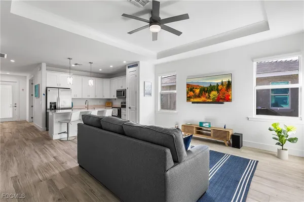a living room with furniture and a kitchen view