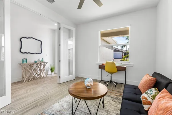 a living room with furniture and a wooden floor