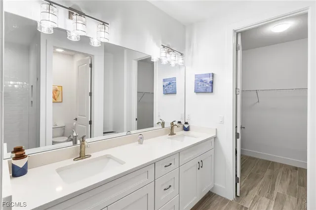 a bathroom with a sink double vanity and a mirror