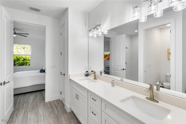 a bathroom with a double vanity sink and a mirror