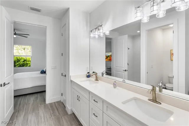 a bathroom with a double vanity sink and a mirror