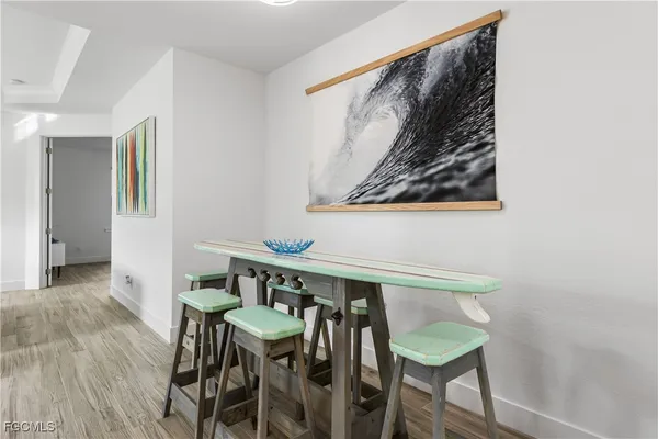 a view of a dining room with furniture and wooden floor